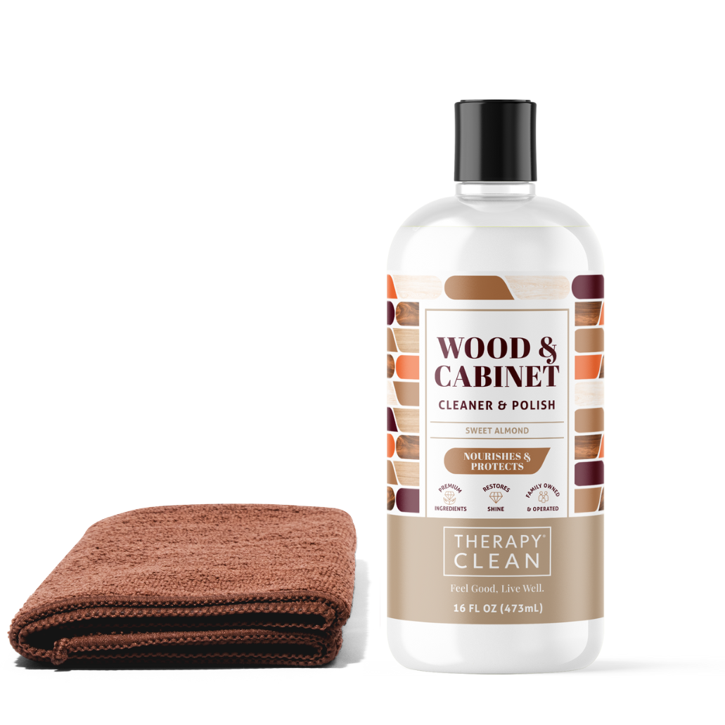 Wood & Cabinet Cleaner Kit featuring a white bottle with a white label, positioned next to a brown towel, designed to clean and nourish wood surfaces.