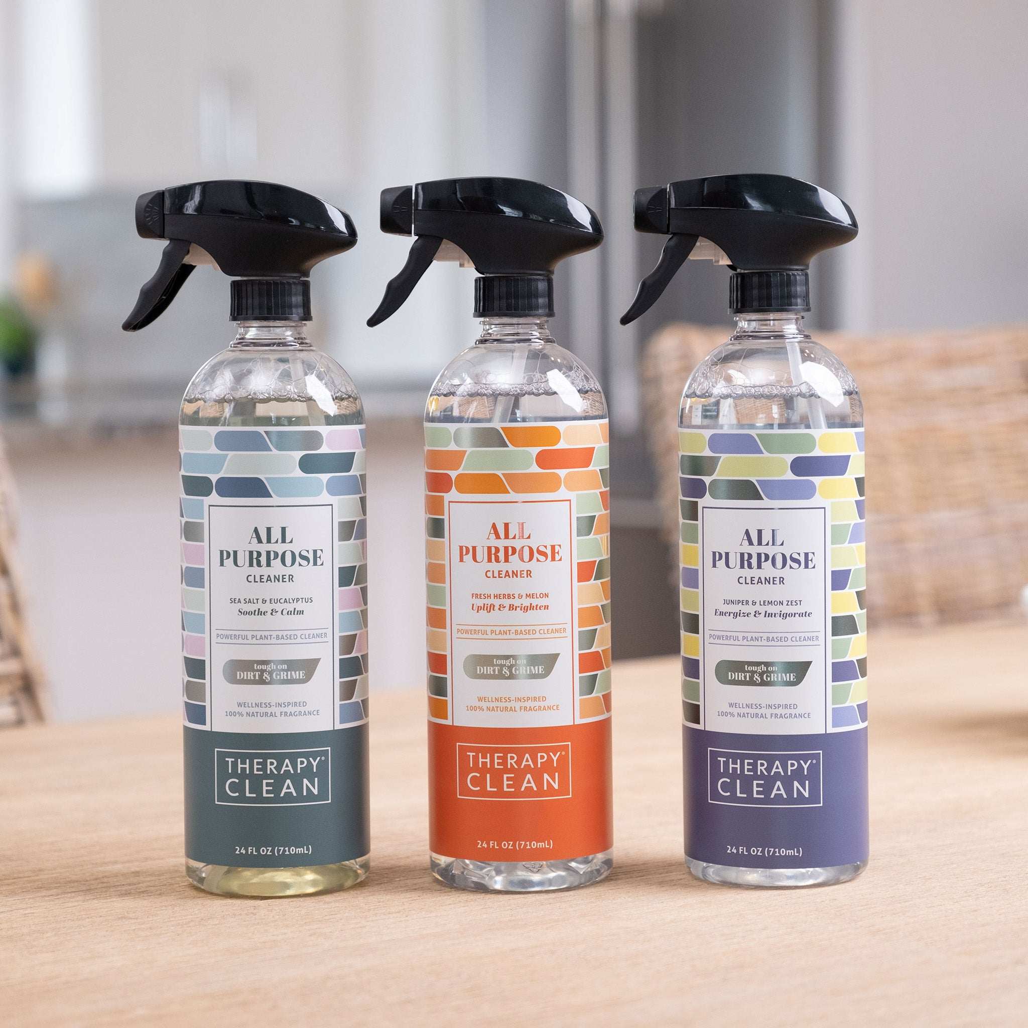 All-Purpose Cleaner - 3 Pack featuring bottles on a table with black sprayers, ideal for cutting through grime on various hard surfaces.